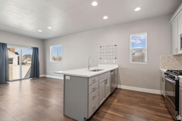 1722 W Shade Ln, Riverton, UT 84065 - kitchen featuring gray cabinetry, a sink, dark wood finished floors, stainless steel appliances, and a peninsula