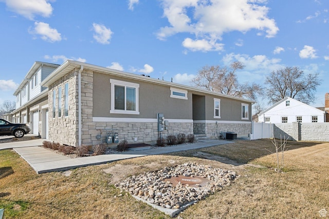 1722 W Shade Ln, Riverton, UT 84065 - exterior space with a yard, fence, stone siding, and central AC