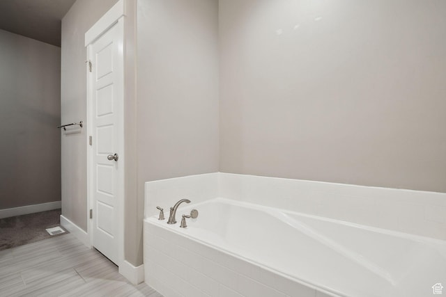 1722 W Shade Ln, Riverton, UT 84065 - bathroom with a bath, visible vents, and baseboards