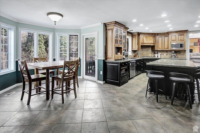 6464 Bybee Dr, Ogden, UT 84403 - kitchen featuring crown molding, a wealth of natural light, backsplash, and appliances with stainless steel finishes
