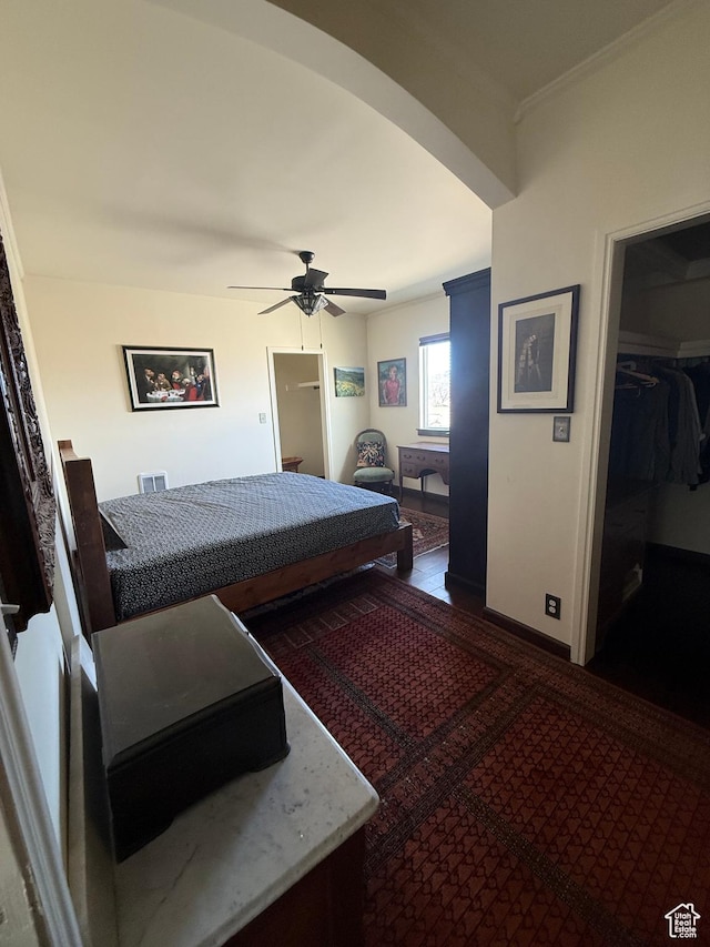 25 Avenue E, Mc Gill, NV 89318 - bedroom featuring baseboards, arched walkways, ceiling fan, ornamental molding, and a spacious closet
