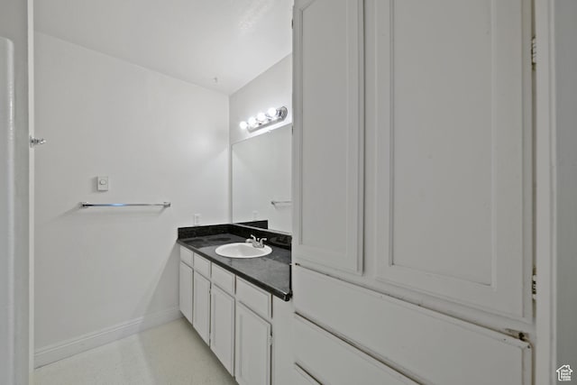 bathroom featuring baseboards and vanity
