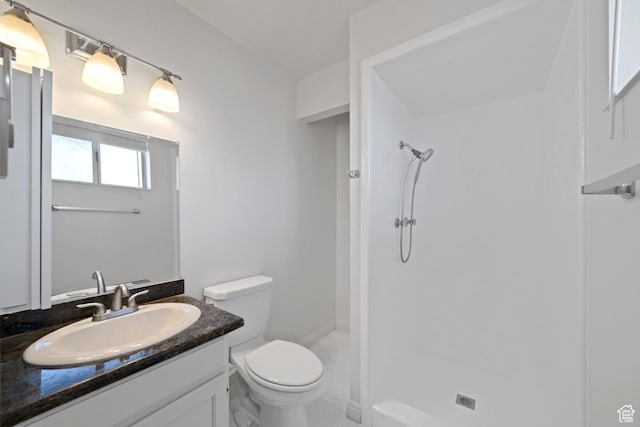 full bathroom with vanity, toilet, and a stall shower