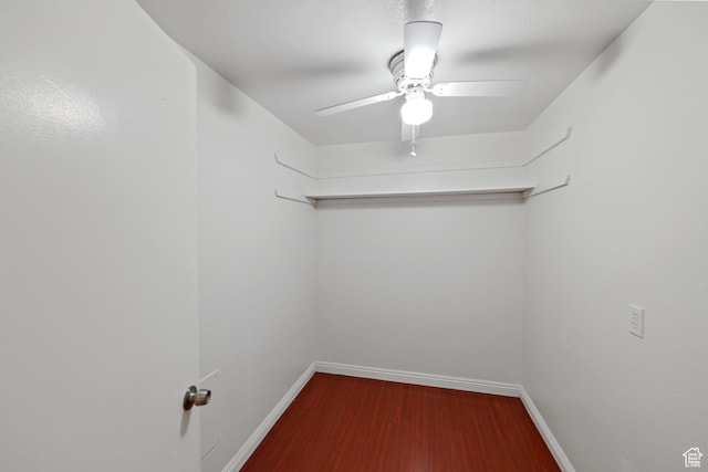 empty room with baseboards, wood finished floors, and a ceiling fan