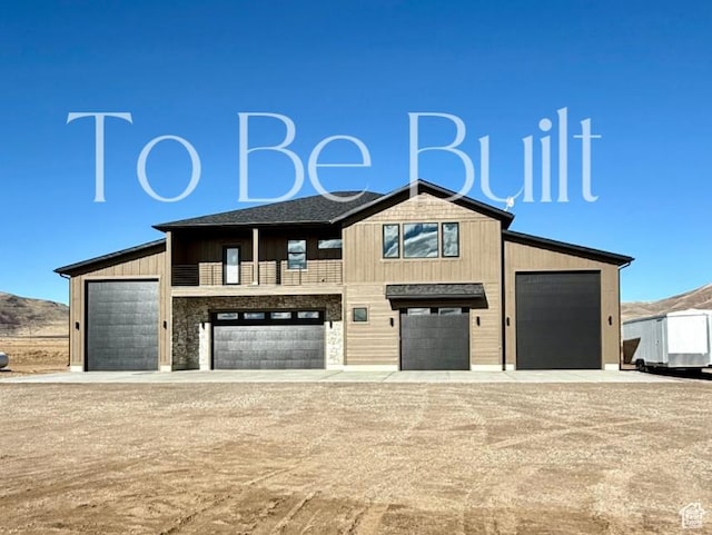 view of front of home with driveway and a mountain view