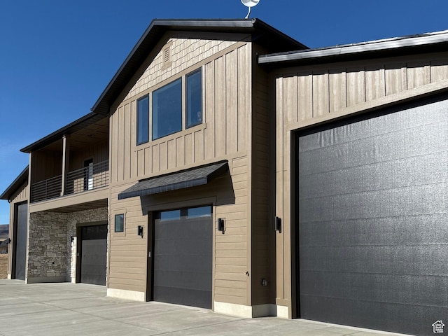 13342 N 10800 W Unit 7, Tremonton, UT 84337 - contemporary house with board and batten siding, a balcony, and a garage
