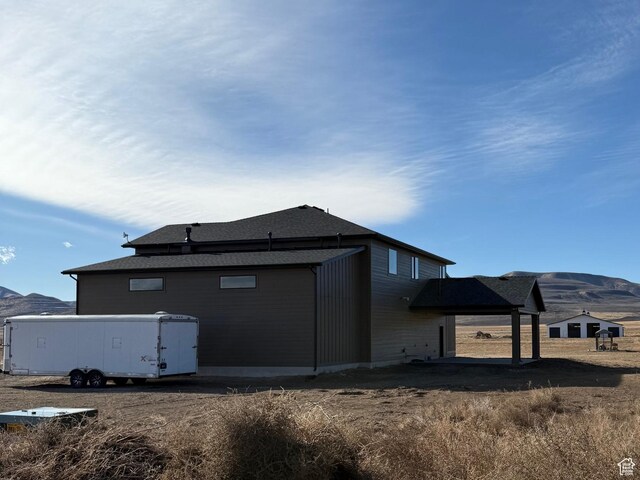 13342 N 10800 W Unit 7, Tremonton, UT 84337 - back of house with a mountain view and a shingled roof