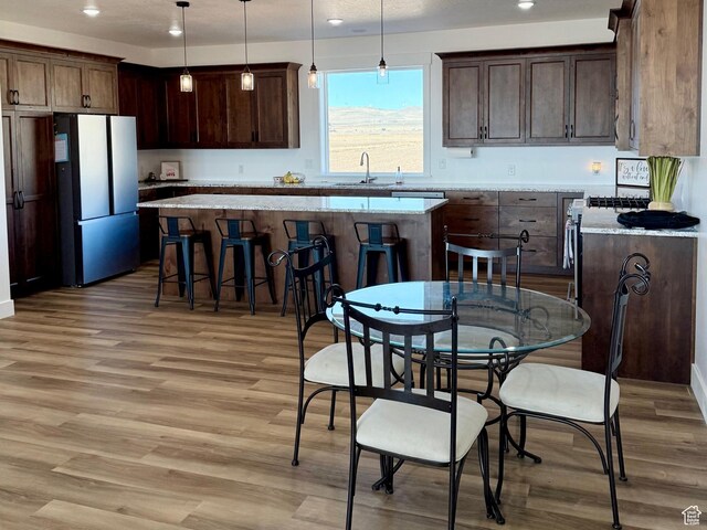 13342 N 10800 W Unit 7, Tremonton, UT 84337 - kitchen with light wood-style floors, a sink, a center island, and freestanding refrigerator