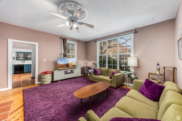 311 N 300 W, Kanab, UT 84741 - living area with baseboards, a ceiling fan, wood finished floors, and a textured ceiling