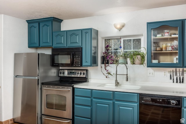 311 N 300 W, Kanab, UT 84741 - kitchen featuring black appliances, blue cabinetry, a sink, and light countertops
