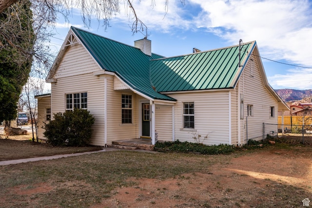 311 N 300 W, Kanab, UT 84741 - view of front of property with a standing seam roof, a chimney, metal roof, and fence
