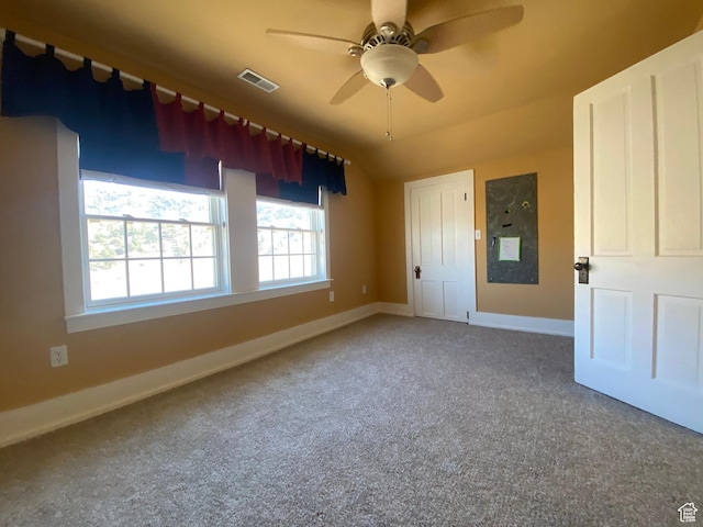 unfurnished bedroom with baseboards, a ceiling fan, visible vents, and carpet