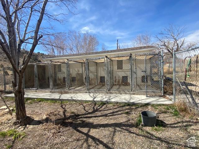 back of property featuring an outdoor structure and an exterior structure