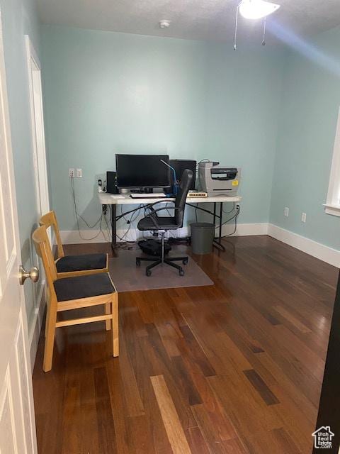 office area featuring baseboards and wood finished floors