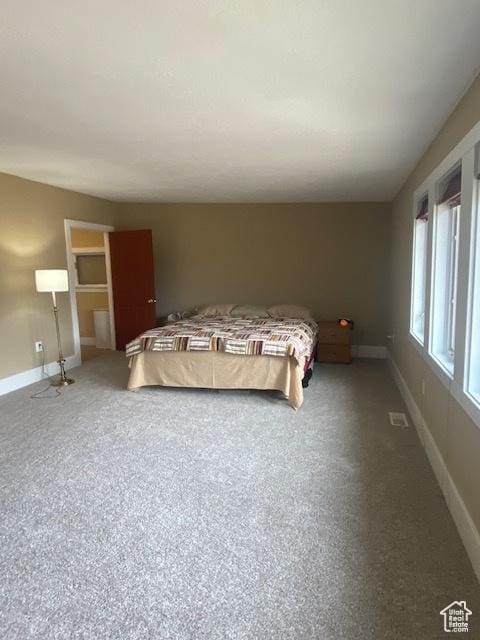 bedroom featuring baseboards and visible vents