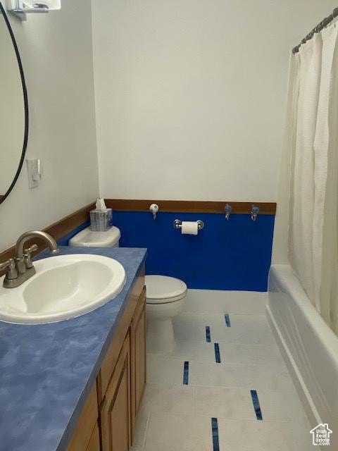 bathroom featuring toilet, tile patterned flooring, and vanity