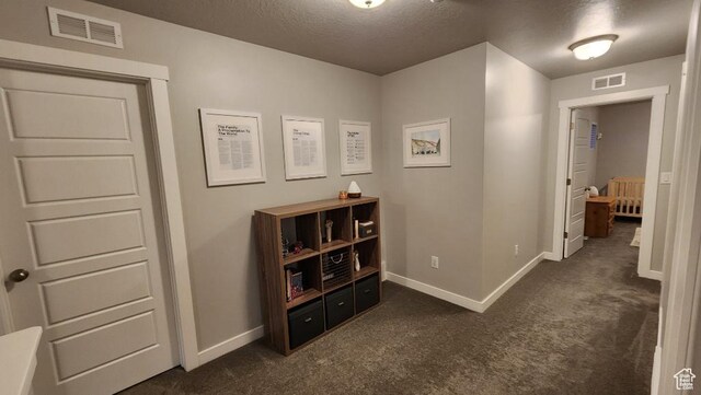 1395 E Kelsey Dr, Eagle Mountain, UT 84005 - corridor with baseboards, visible vents, and dark colored carpet