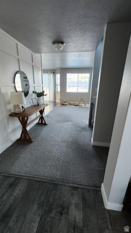 1395 E Kelsey Dr, Eagle Mountain, UT 84005 - corridor featuring baseboards, a textured ceiling, and wood finished floors
