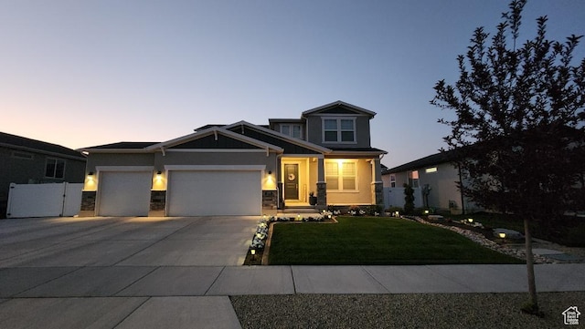 1395 E Kelsey Dr, Eagle Mountain, UT 84005 - craftsman-style house with concrete driveway, stucco siding, an attached garage, stone siding, and a lawn