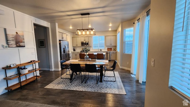 1395 E Kelsey Dr, Eagle Mountain, UT 84005 - dining space featuring dark wood finished floors and baseboards