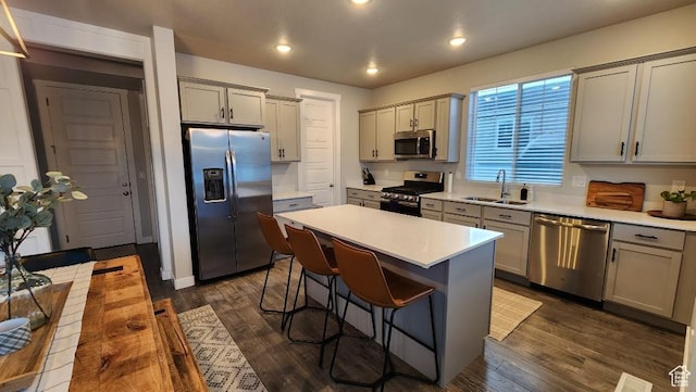 1395 E Kelsey Dr, Eagle Mountain, UT 84005 - kitchen with a breakfast bar, a sink, stainless steel appliances, and gray cabinets