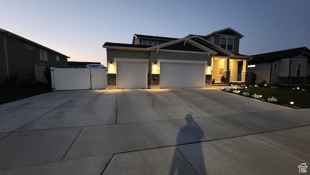 1395 E Kelsey Dr, Eagle Mountain, UT 84005 - view of front of house featuring stone siding, stucco siding, concrete driveway, and a garage