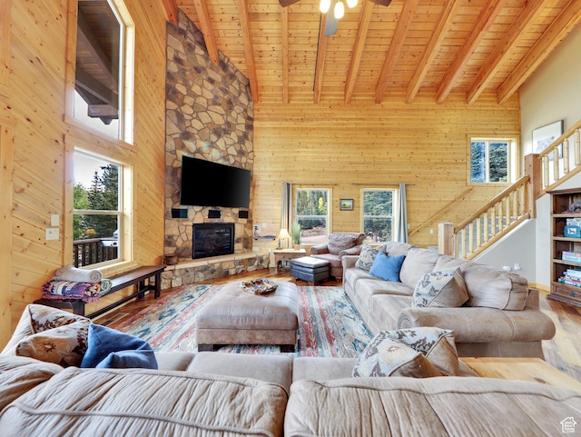 161 N Irish Trl, Brian Head, UT 84719 - living room with beam ceiling, wood finished floors, a stone fireplace, wood walls, and wood ceiling