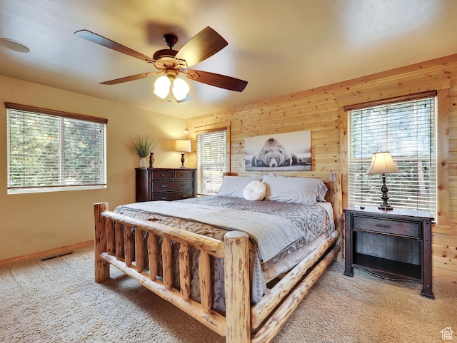 161 N Irish Trl, Brian Head, UT 84719 - bedroom featuring wooden walls, baseboards, visible vents, ceiling fan, and light carpet