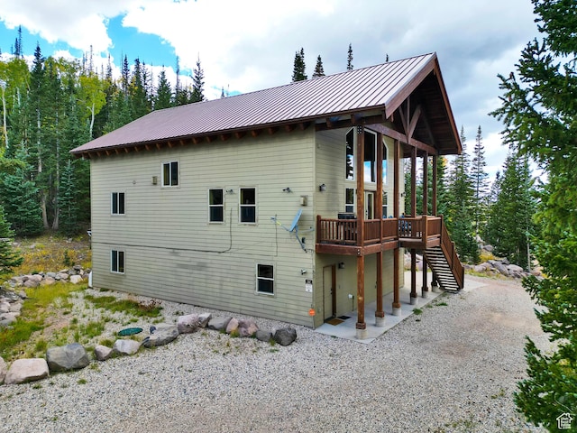 161 N Irish Trl, Brian Head, UT 84719 - rear view of house featuring stairs, a wooden deck, a standing seam roof, and metal roof