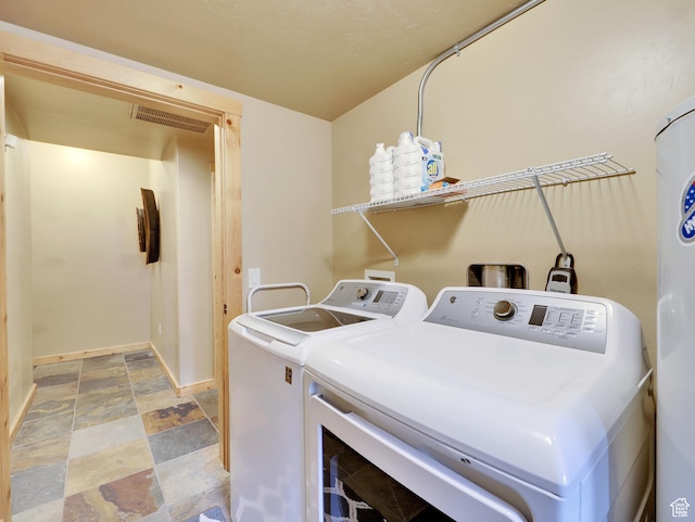 161 N Irish Trl, Brian Head, UT 84719 - clothes washing area featuring visible vents, stone finish floor, separate washer and dryer, baseboards, and laundry area