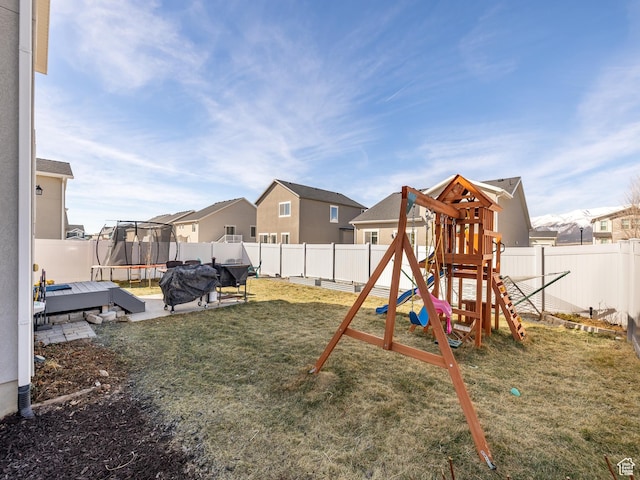 6119 N White Rock Rd, Eagle Mountain, UT 84005 - view of jungle gym featuring a trampoline, a fenced backyard, a yard, and a residential view