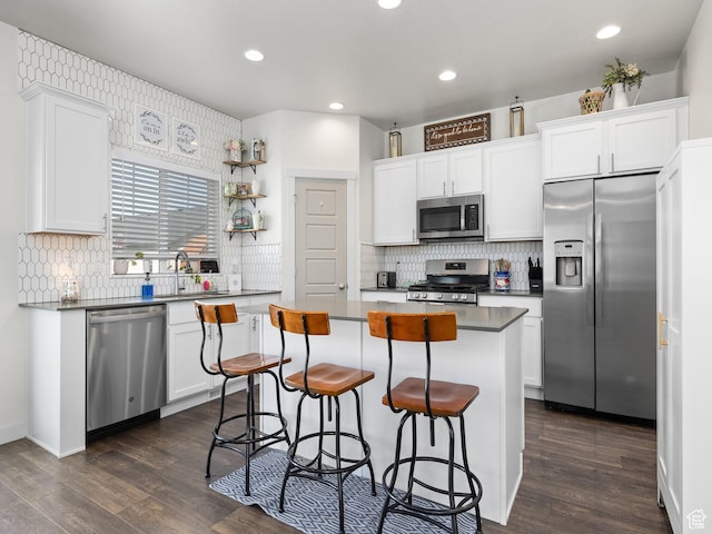 6119 N White Rock Rd, Eagle Mountain, UT 84005 - kitchen with a breakfast bar area, appliances with stainless steel finishes, white cabinets, and a center island