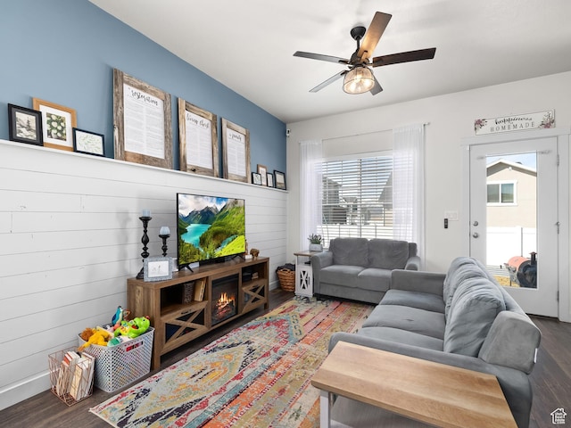 6119 N White Rock Rd, Eagle Mountain, UT 84005 - living room with plenty of natural light, a warm lit fireplace, wood finished floors, and a ceiling fan