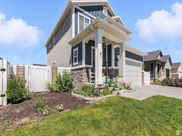 6119 N White Rock Rd, Eagle Mountain, UT 84005 - view of front of home with a gate, concrete driveway, an attached garage, stone siding, and a porch
