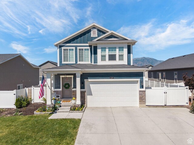 6119 N White Rock Rd, Eagle Mountain, UT 84005 - craftsman-style home featuring a gate, an attached garage, concrete driveway, board and batten siding, and stone siding