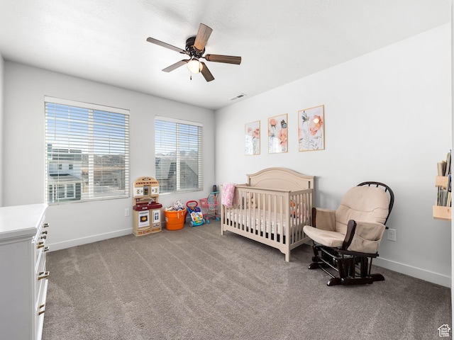 6119 N White Rock Rd, Eagle Mountain, UT 84005 - bedroom with visible vents, a crib, a ceiling fan, carpet floors, and baseboards