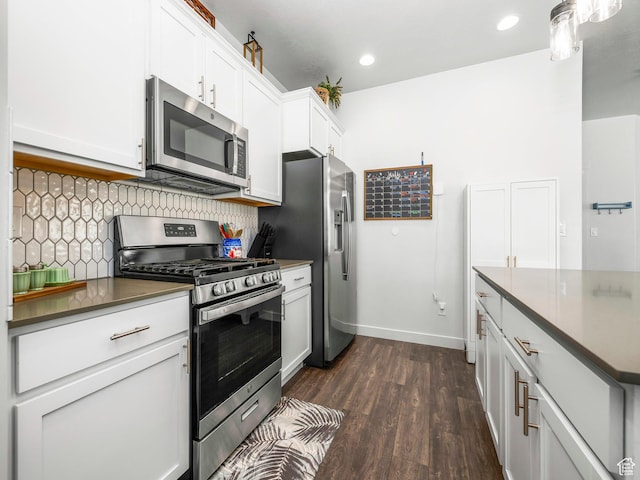6119 N White Rock Rd, Eagle Mountain, UT 84005 - kitchen with stainless steel appliances, decorative backsplash, dark wood finished floors, white cabinetry, and dark countertops