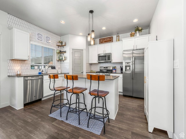 6119 N White Rock Rd, Eagle Mountain, UT 84005 - kitchen with stainless steel appliances, a center island, white cabinets, tasteful backsplash, and recessed lighting