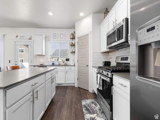 6119 N White Rock Rd, Eagle Mountain, UT 84005 - kitchen featuring white cabinets, appliances with stainless steel finishes, and dark wood-style flooring