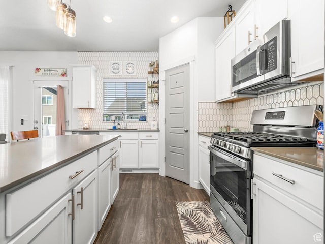 6119 N White Rock Rd, Eagle Mountain, UT 84005 - kitchen featuring appliances with stainless steel finishes, white cabinetry, decorative backsplash, dark wood-style floors, and recessed lighting
