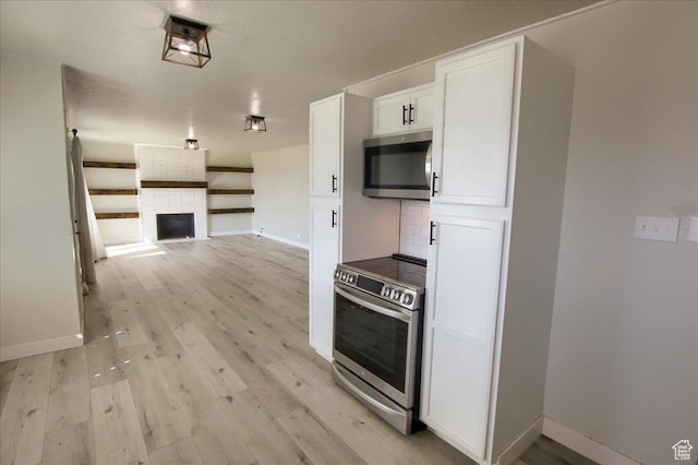 454 E 3100 N, North Ogden, UT 84414 - kitchen with decorative backsplash, light wood-style flooring, white cabinets, and stainless steel appliances