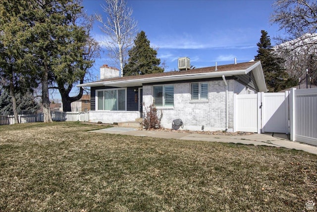 454 E 3100 N, North Ogden, UT 84414 - view of front of home with brick siding, fence, a front yard, a chimney, and a gate