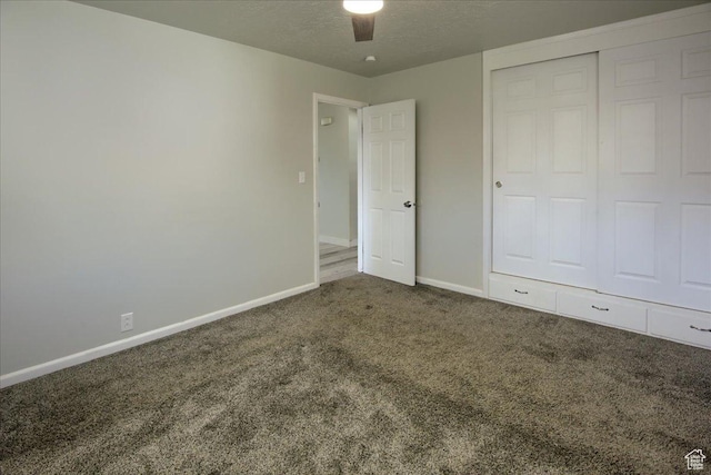 454 E 3100 N, North Ogden, UT 84414 - unfurnished bedroom featuring a closet, baseboards, a textured ceiling, and carpet flooring