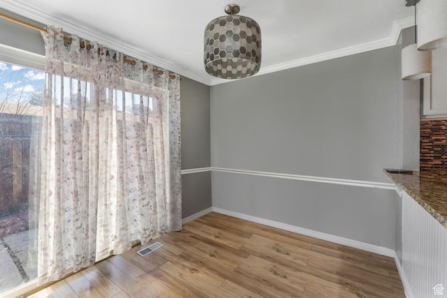 4201 S 2260 W, Taylorsville, UT 84129 - unfurnished dining area with visible vents, baseboards, wood finished floors, and crown molding