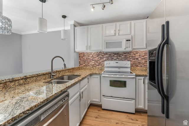 4201 S 2260 W, Taylorsville, UT 84129 - kitchen featuring light wood-type flooring, a sink, appliances with stainless steel finishes, crown molding, and decorative backsplash