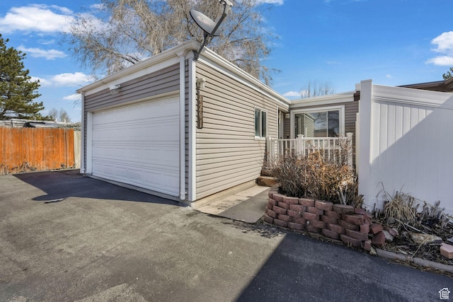 4201 S 2260 W, Taylorsville, UT 84129 - view of side of home with a garage, driveway, and fence
