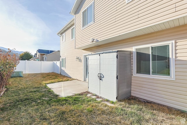 exterior space featuring a lawn, a patio, and fence