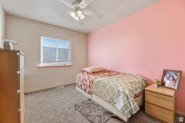 bedroom featuring visible vents, baseboards, a ceiling fan, and carpet flooring