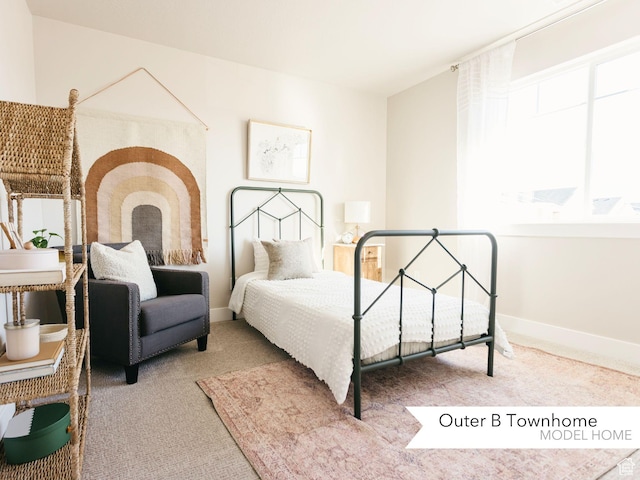 carpeted bedroom with baseboards and multiple windows