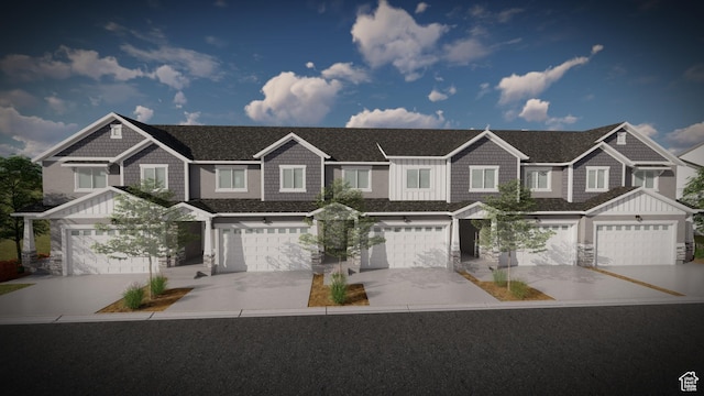 view of front of home with driveway, stone siding, roof with shingles, board and batten siding, and a garage